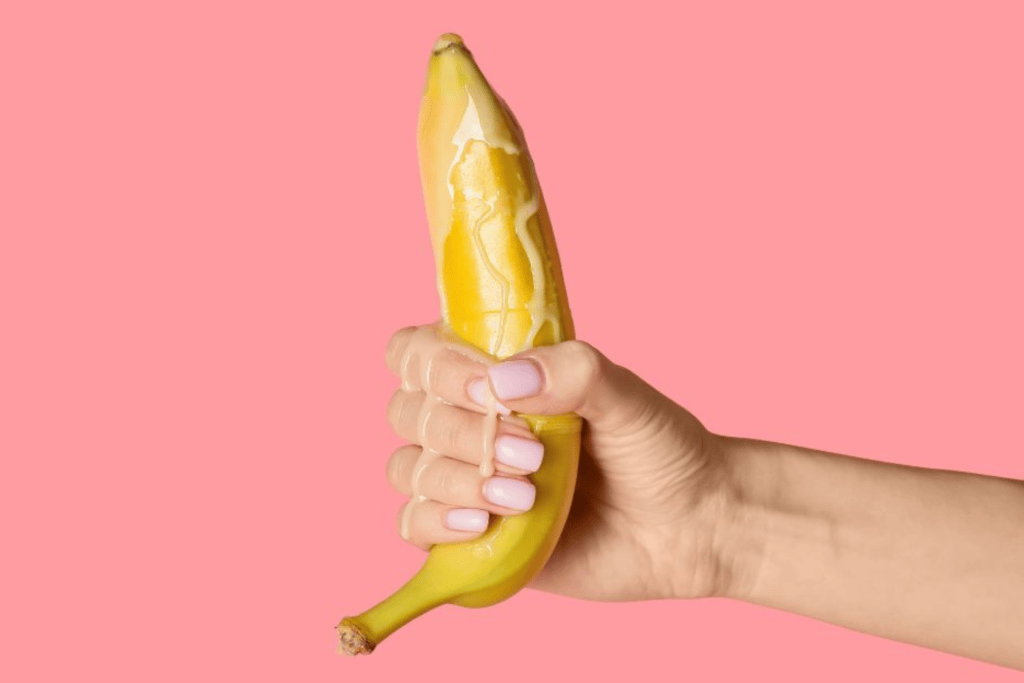Reference to man's orgasm. Banana in hand with dripping cream from top to bottom of hand.