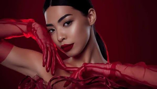 Beautiful Asian Goddess Jasmine posing in red mesh gloves.