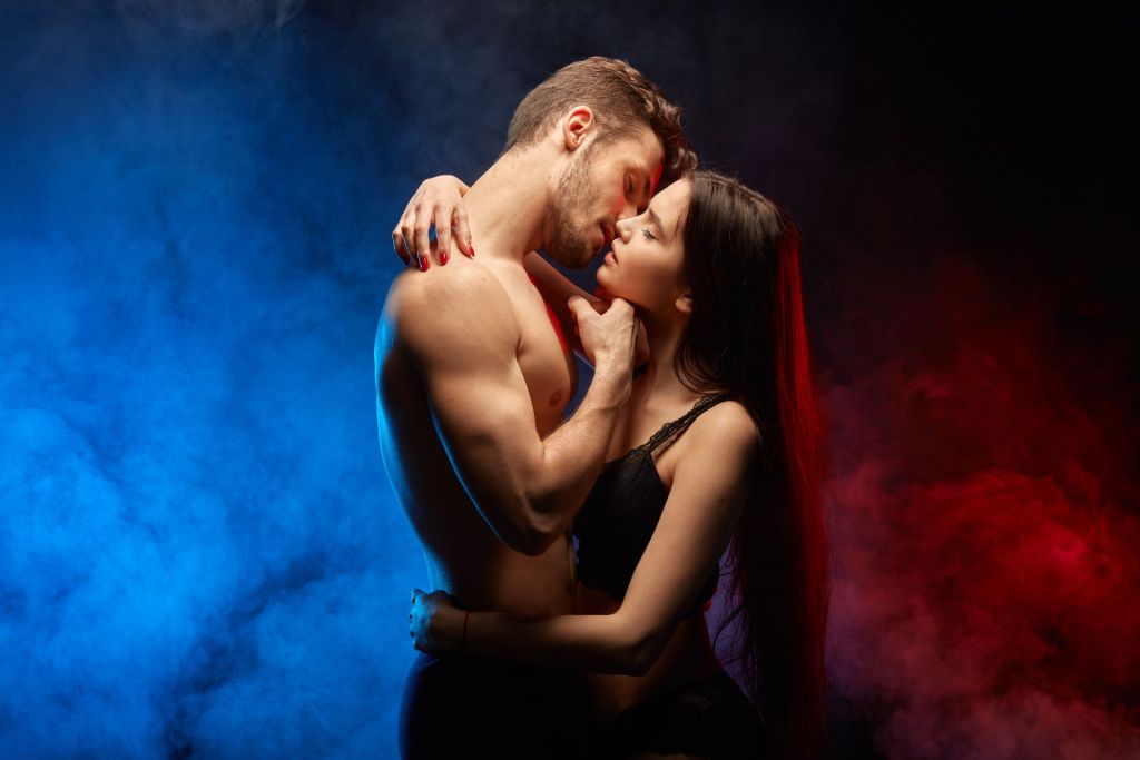 Man in hugs of a woman asking her to stimulate his g-spot during their foreplay