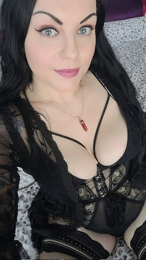 Goddess Amy Wynters posing in black lace semi-transparent dress