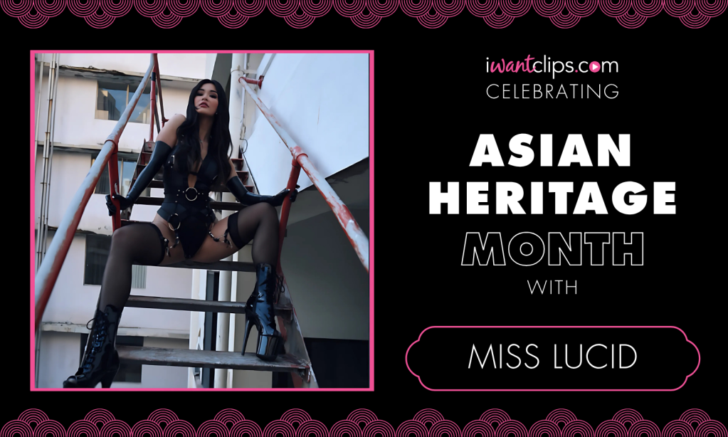 Static banner with Miss Lucid is sitting on top of a metal industrial ladder with spread legs in a black bodysuit, black stockings, black high-heeled boots and looking down and signature iWantClips.com CELEBRATING ASIAN HERITAGE MONTH with MISS LUCID